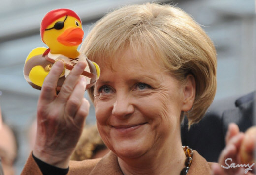 Bundeskanzlerin Angela Merkel mit dem Maskottchen der Blockade-Aktion Neckar-CASTOR - Collage: Samy - Creative-Commons-Lizenz Namensnennung Nicht-Kommerziell 3.0